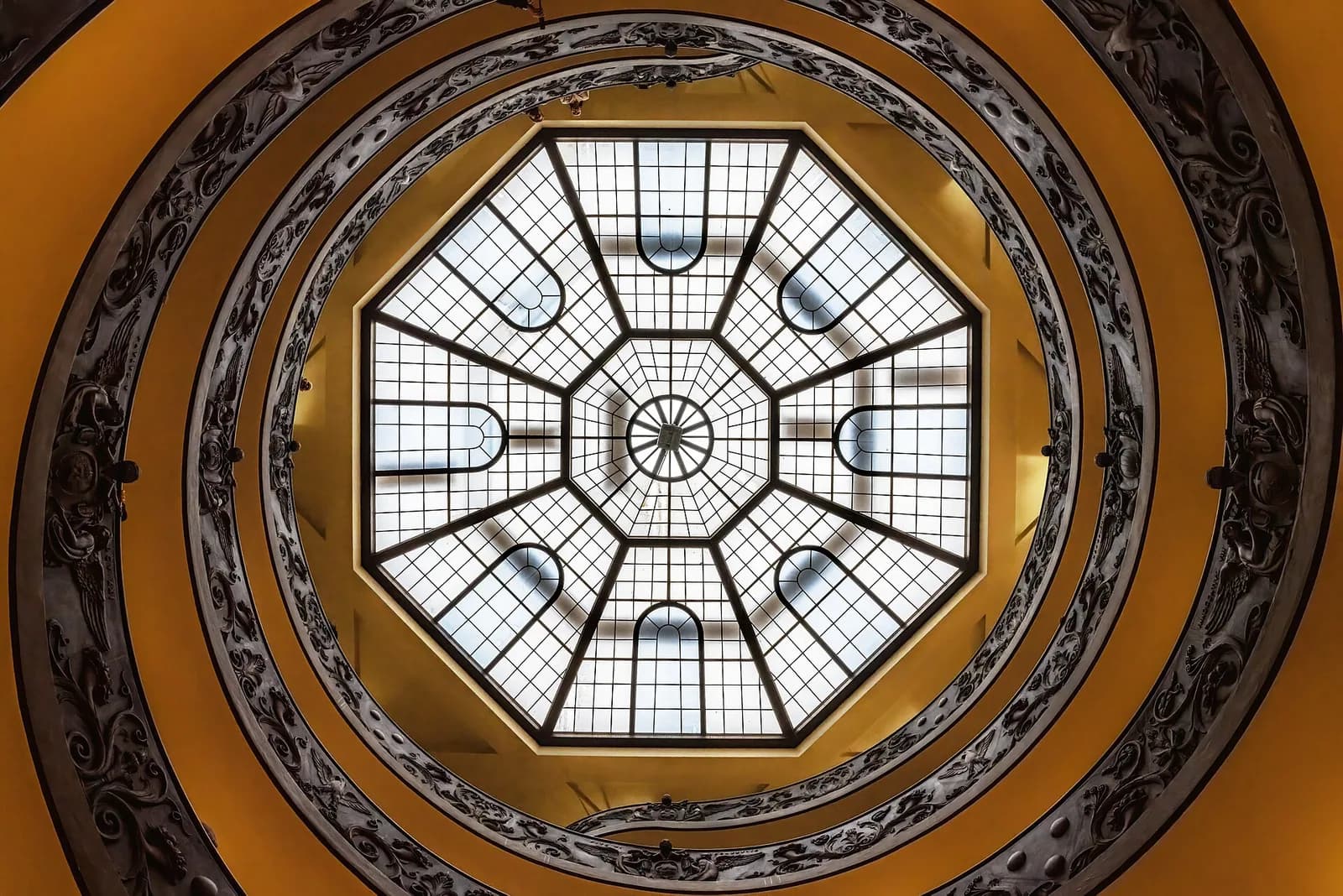 Looking upward through the spiral staircase at the Vatican Museums.